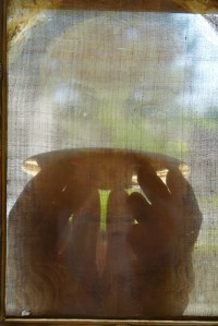 Priest elevating Eucharist on paten viewed through the Veil of the Holy Face of Manoppello. Photo: Paul Badde