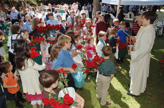 Children come in procession for "the blessing of the roses." 