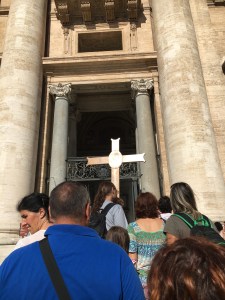 Pilgrims carrying the Jubilee of Mercy Cross into the Holy Door of St. Peter's